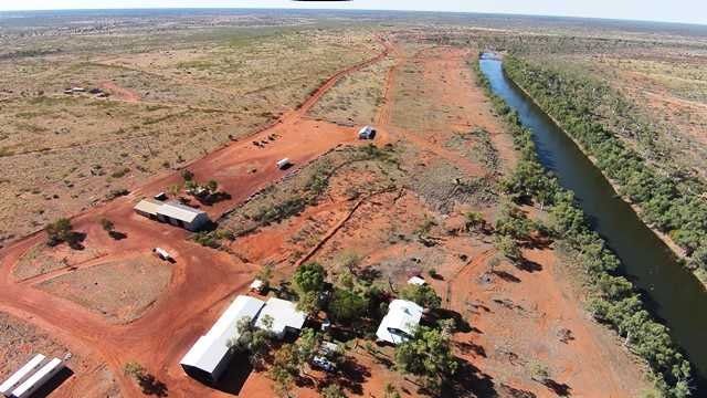 a cattle station homestead next to a river.