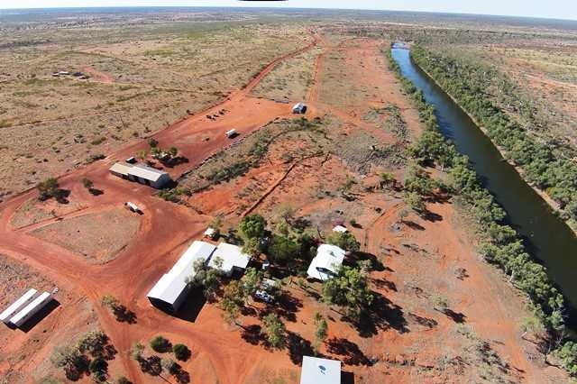 A cattle station homestead next to a river.