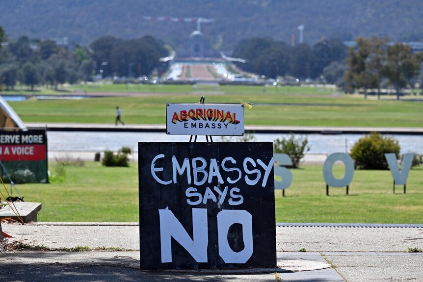 A sign reads 'Embassy says No' at the front of the Aboriginal Tent Embassy