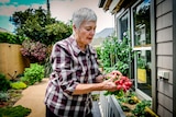 Ms Goldsmith in her garden with a bunch of radishes