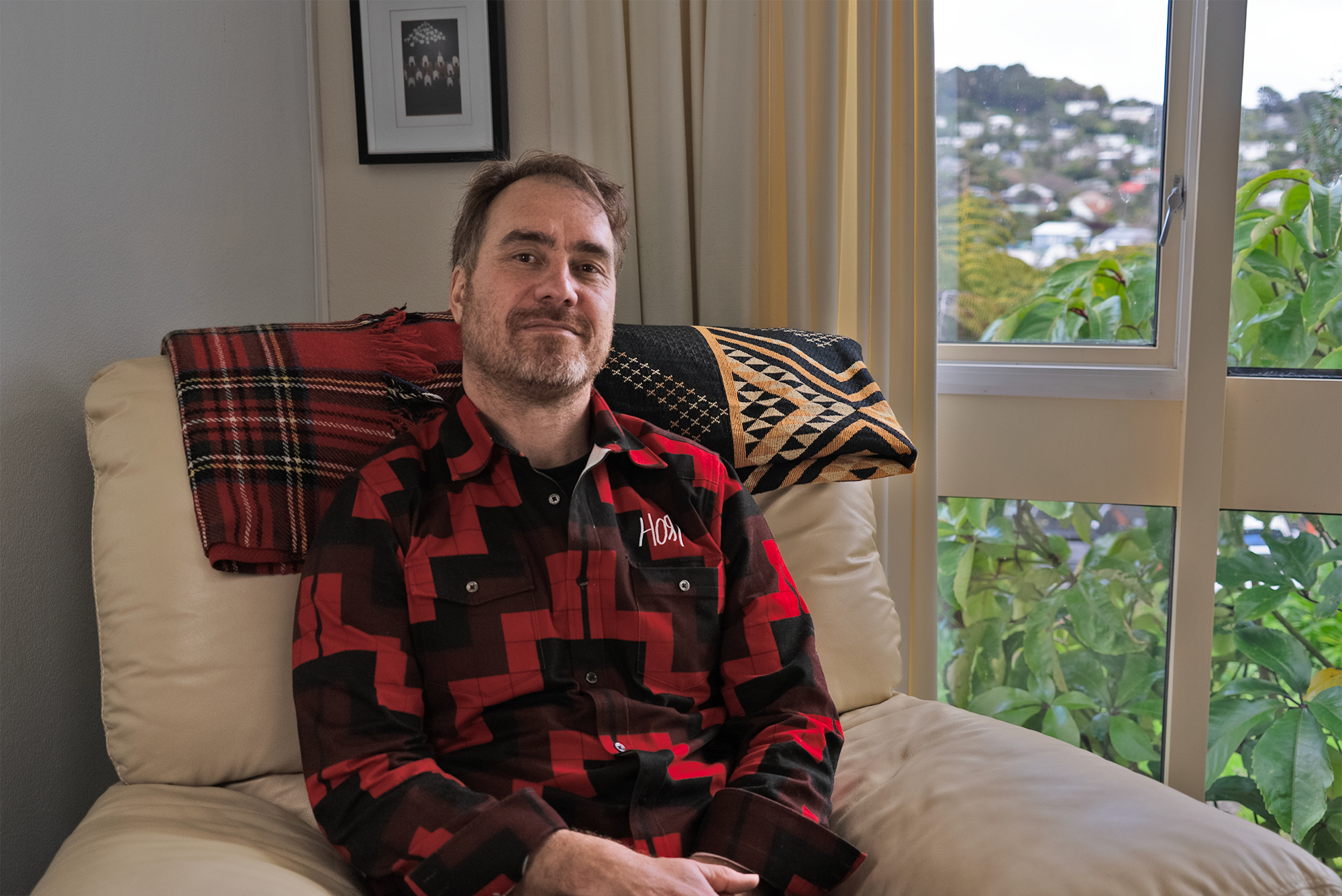 Haora sitting inside his Wellington home.