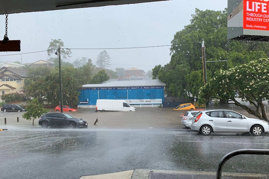 Cars sit in flash flooding off a major road into the city from the south.