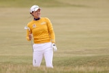 Australia's Minjee Lee holds her club in her hand as she looks down the fairway after hitting an approach shot.