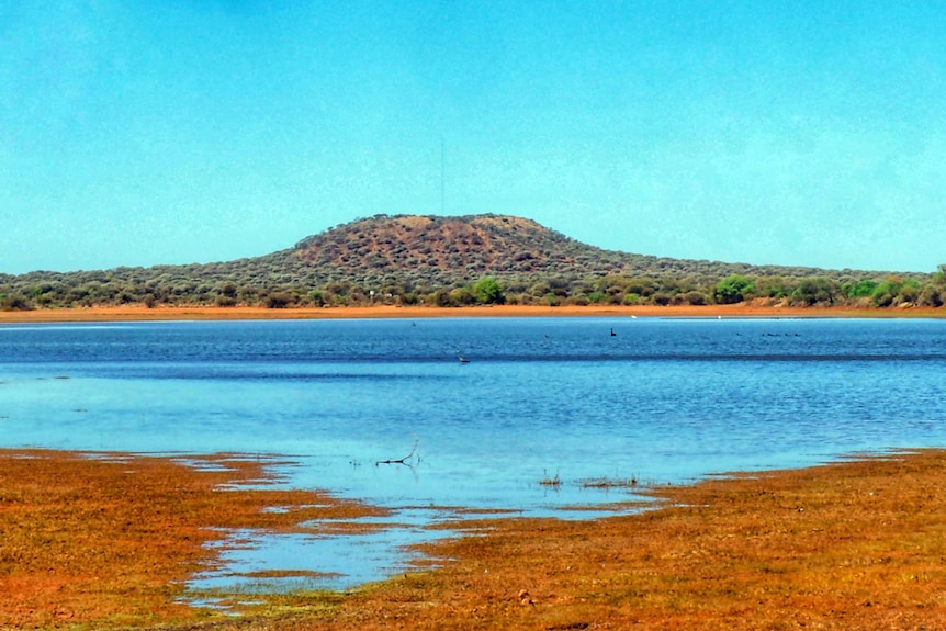 A dam surrounded by red dirt