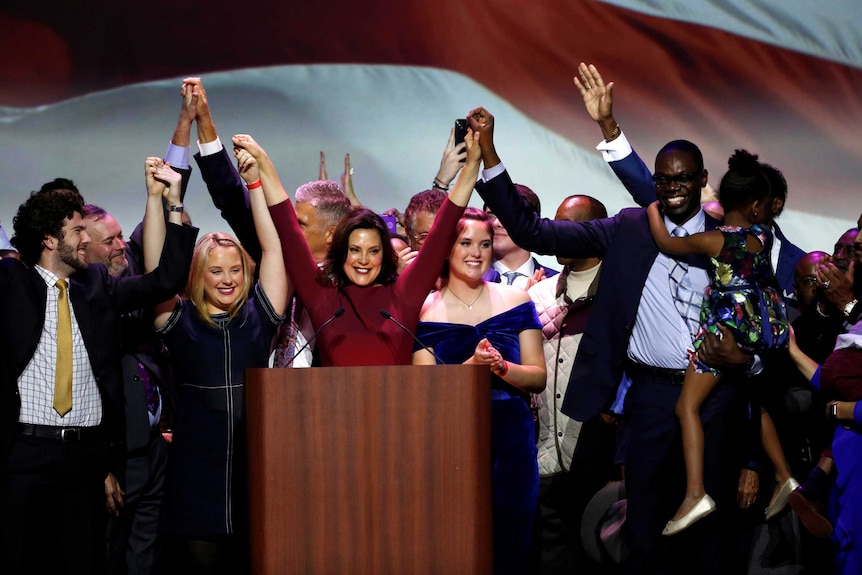 Democratic gubernatorial candidate Gretchen Whitmer reacts with her lieutenant Governor-elect Garlin Gilchrist.