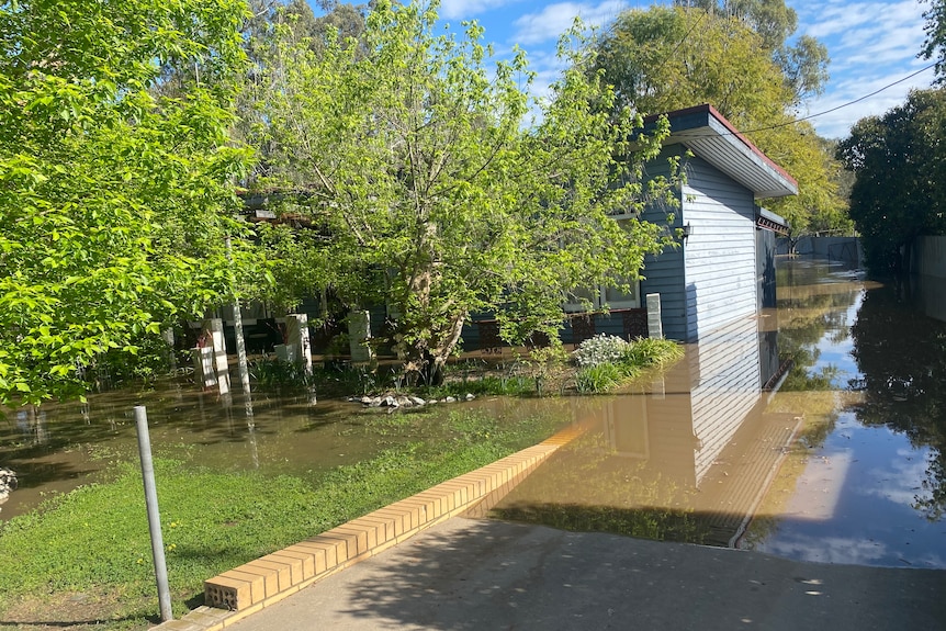 A house under a few feet of water.