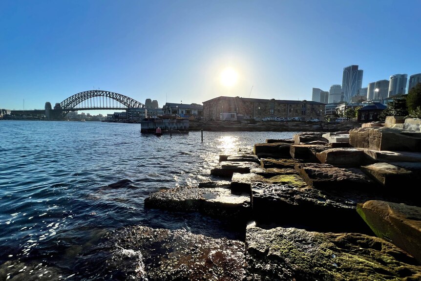 Water and rocks with Sydney Harbour Bridge in background