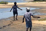 Indigenous children hunting on a beach.