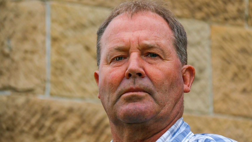 Paramedic Peter Stride standing tall in front of a brick wall