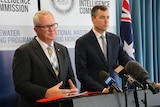 ACIC chief executive officer Chris Dawson stands alongside the Federal Justice Minister Michael Keenan