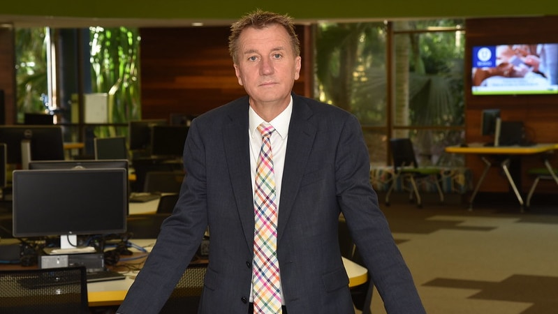 Man in suit standing in library