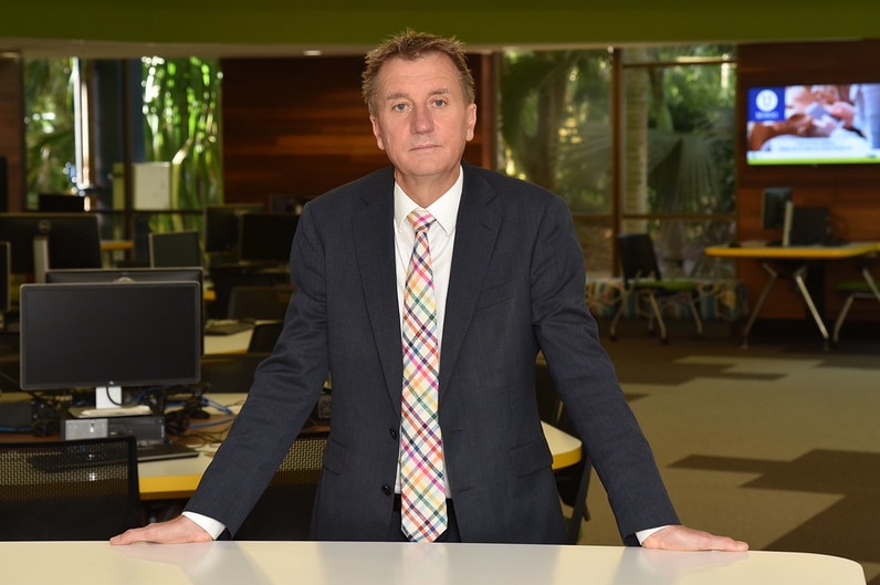 Man in suit standing in library