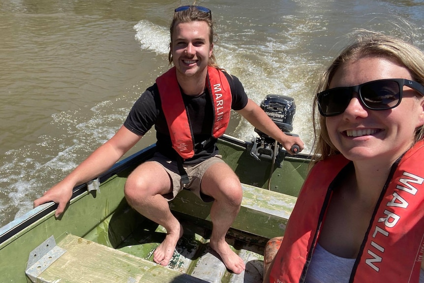 A couple sit in a boat