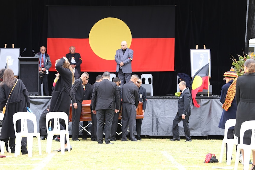 Pallbearers get ready to carry the coffin at Uncle Lyall Munro Senior's funeral