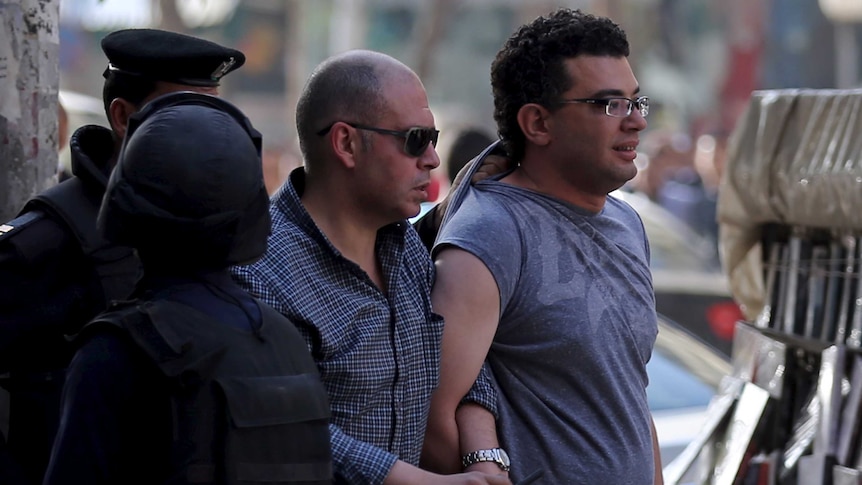 Police officer detains protester during demonstration in Egypt