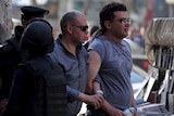 Police officer detains protester during demonstration in Egypt