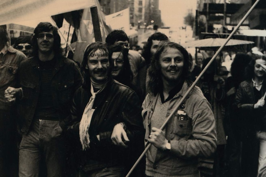 A group of Melbourne students take to the streets in Gay Pride week Melbourne 1973, holding banners.