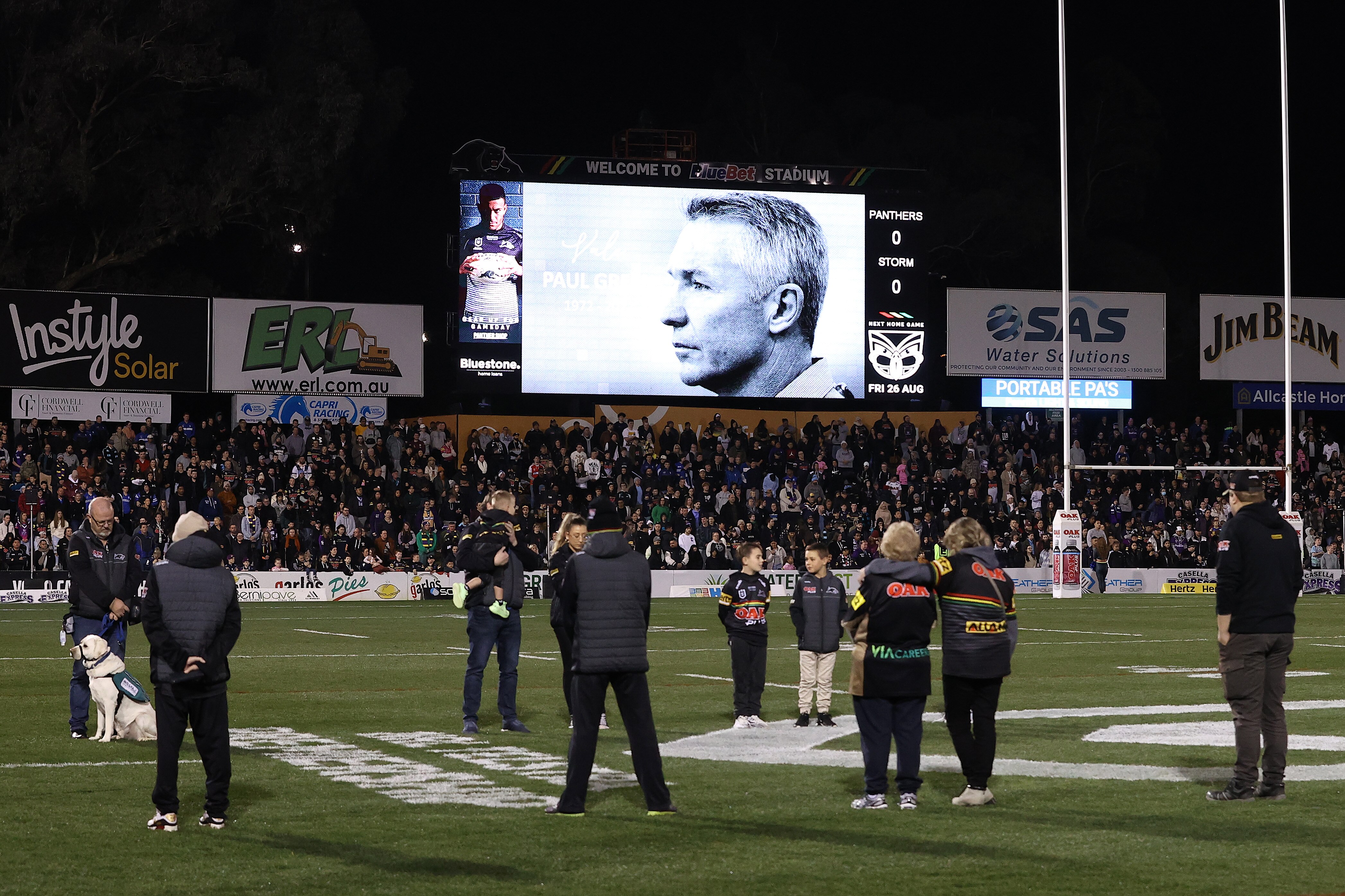 Paul Green's image is displayed on the big screen during a minute's silence before an NRL game at Penrith Stadium.