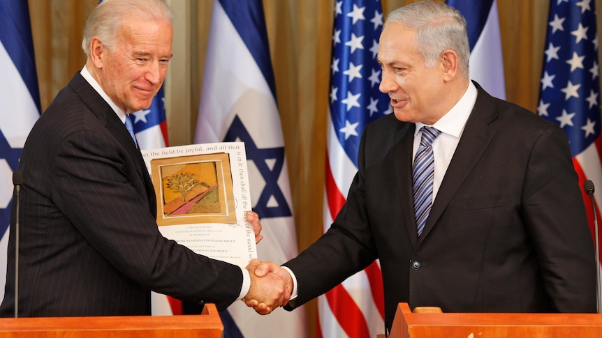 Then-US Vice-President Joe Biden shakes hand with Israel's Prime Minister Benjamin Netanyahu.