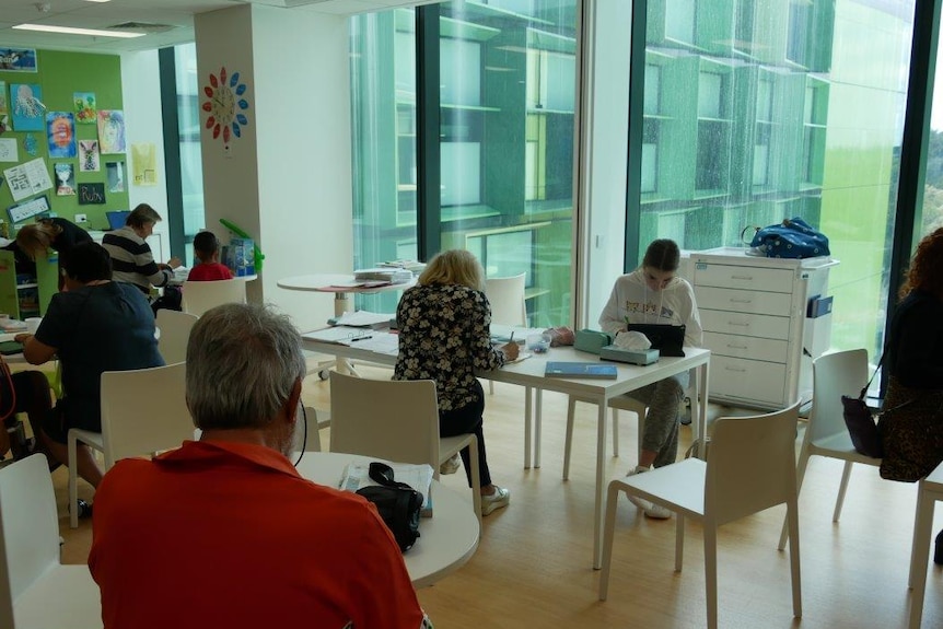 A wide shot showing children sitting down in a classroom at Perth Children's Hospital.