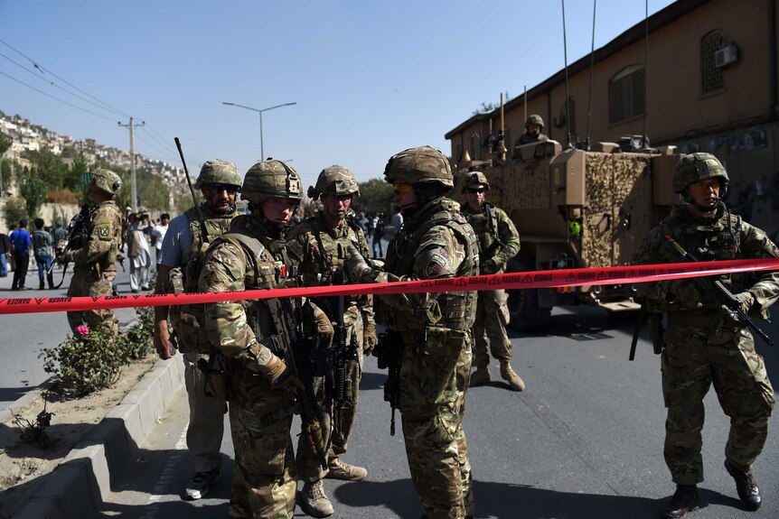 NATO soldiers arrive at the scene of a suicide car bomb in Kabul