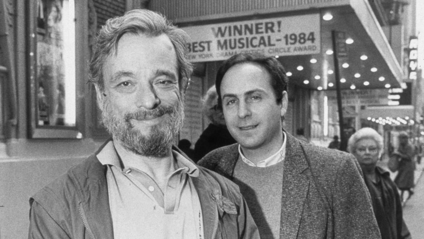 Stephen Sondheim (left) and James Lapine (right) pose for the camera in front of the marquee of the Booth Theatre.