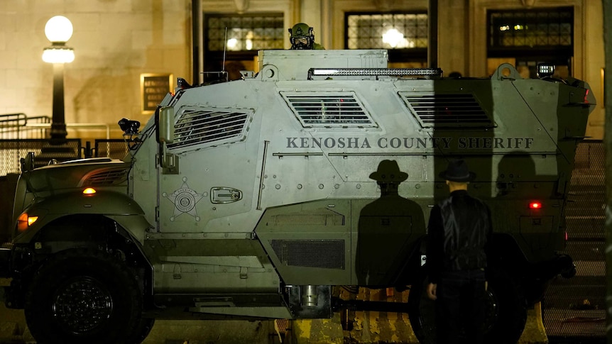 An armoured vehicle from the Kenosha County Sheriff in front of an unarmed protester.