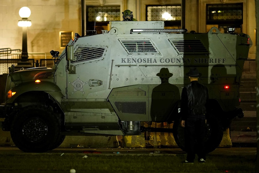 An armoured vehicle from the Kenosha County Sheriff in front of an unarmed protester.
