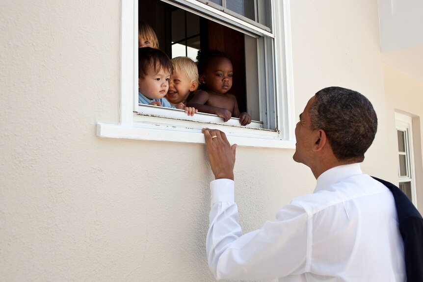 Barack Obama greets children at day care facility