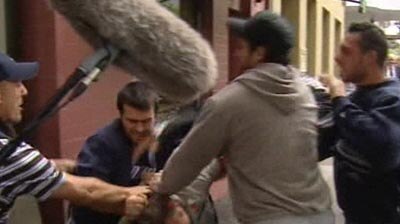 Tensions high ... supporters of the men arrested in Melbourne raids scuffle with TV crews outside court