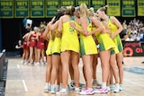 Diamonds players stand in a huddle with their hands in as they de-brief after their third win against England