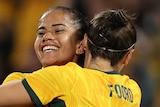Matildas Mary Fowler and Caitlin Foord hug during an Olympic qualifier against Chinese Taipei.