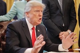 Donald Trump at the signing of his 'one in, two out' executive order