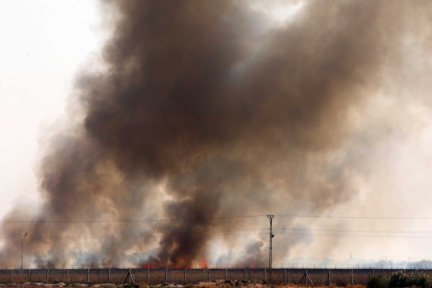 Smoke billows from fires across the border.