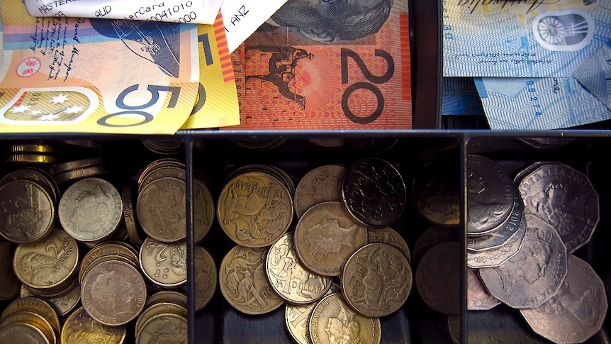 A cash drawer filled with Australian notes and coins.