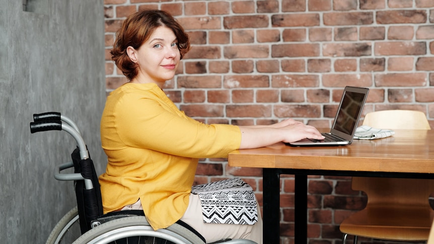 Woman working from home using a wheelchair, in a story about working from home long term.