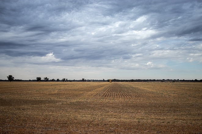 Clouds over recently harvested hay paddock.