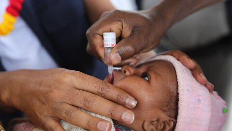 A baby receives polio vaccine