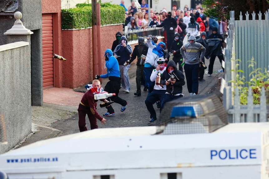 Loyalists throw bottles at police in Belfast after an Orange Parade was blocked from marching.