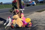 Flowers and teddies at the scene of a double fatality in Tasmania