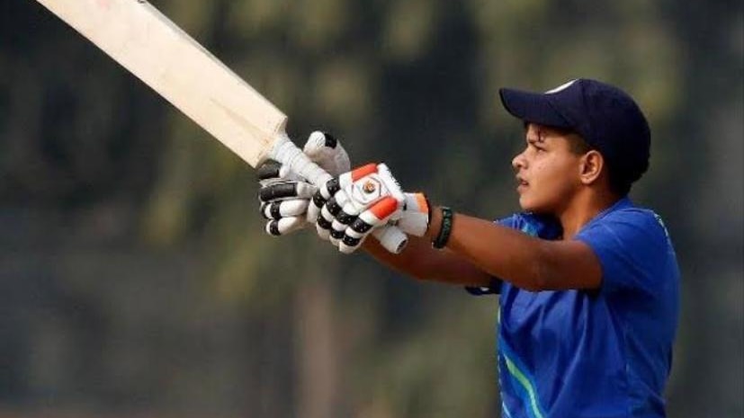 A young Indian female cricketer plays a shot.