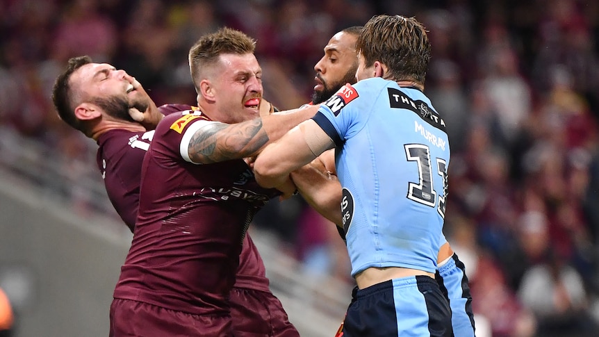 Queensland Maroons Kyle Feldt and Cameron Munster push and shove with NSW Blues Cameron Murray and Josh Addo-Carr.