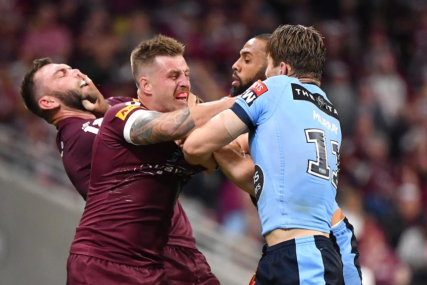 Queensland Maroons Kyle Feldt and Cameron Munster push and shove with NSW Blues Cameron Murray and Josh Addo-Carr.