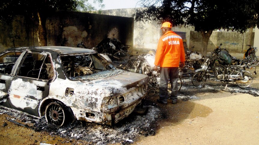 Rescue worker inspects Nigeria bomb blast site