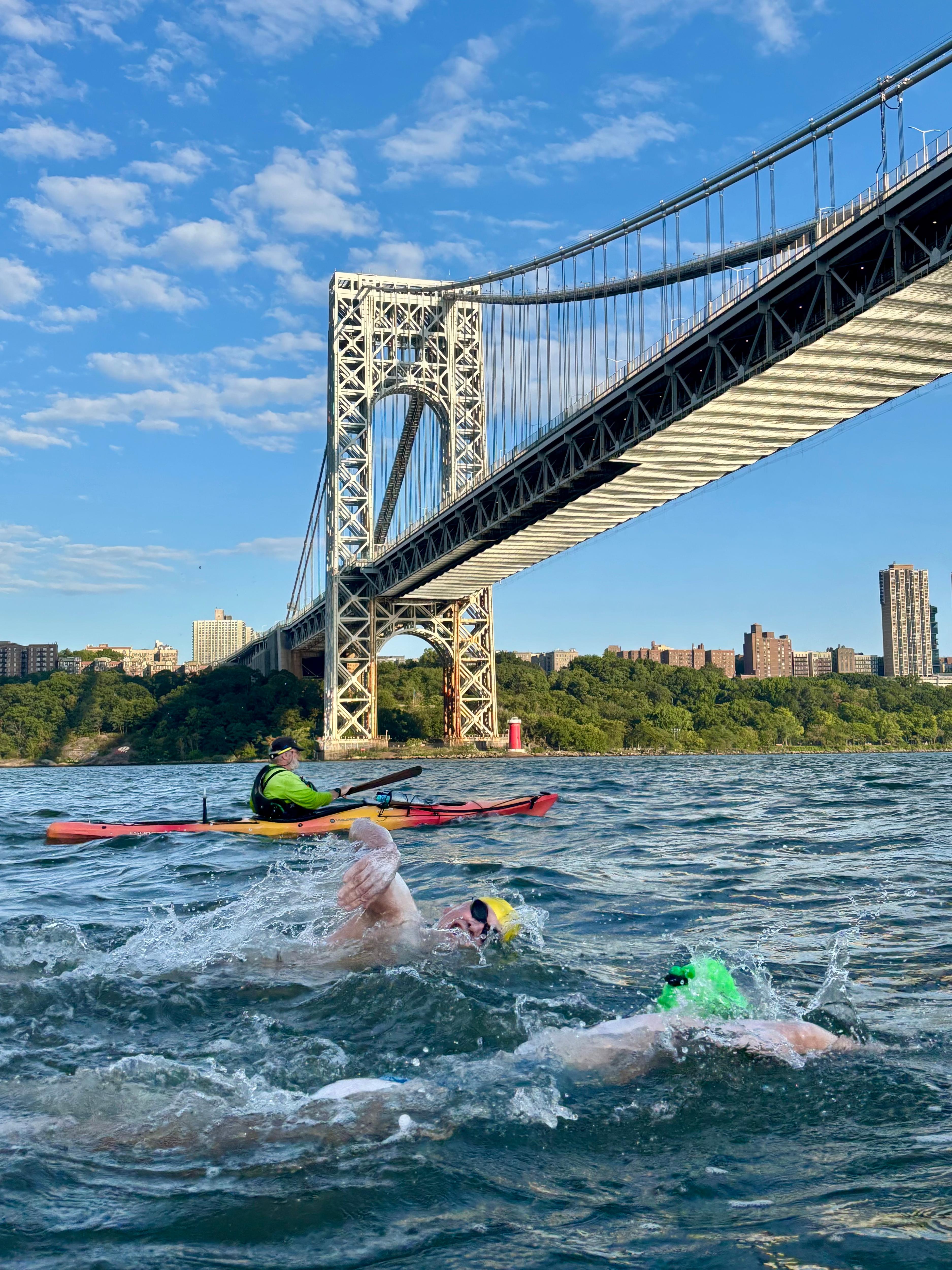 Swimmers under a bridge in Manhattan.