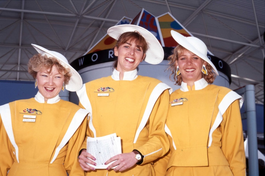Three Expo 88 hostesses smile for a photo