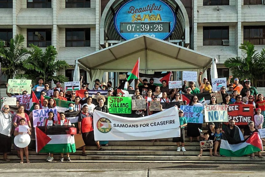 Pro-Palestine protestors in Apia wave Palestinian flags