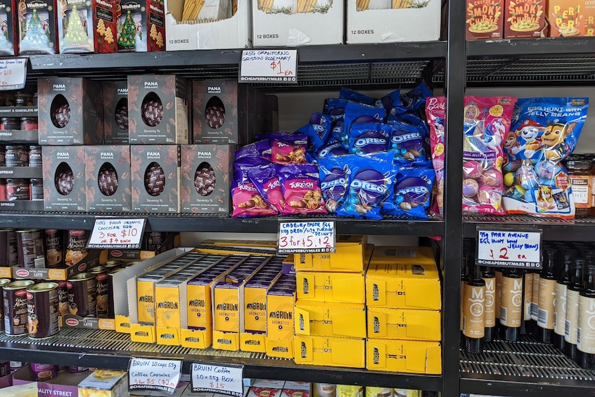 Different types of Easter eggs for sale on shelves in a shop.