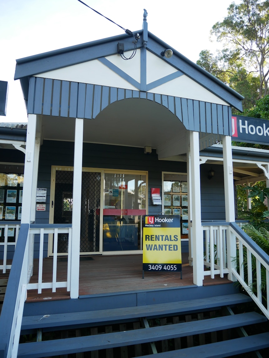 A sign on the deck of a real estate agent reads: RENTALS WANTED