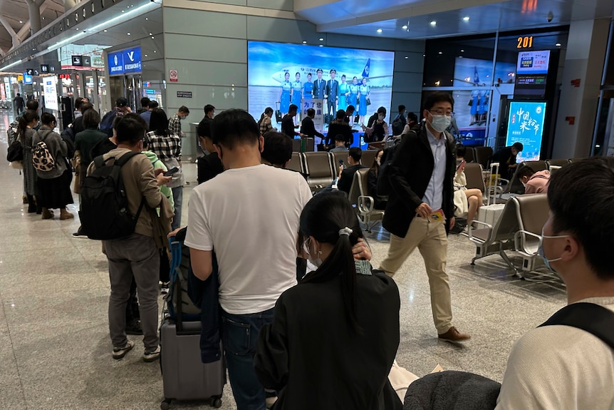 People line up to board a flight at a Chinese airport.